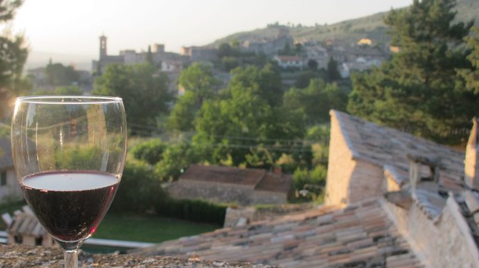 Glass of red wine overlooking Italian sunset view