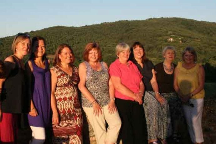 Group of guests in sunny outdoor of villa Arezzo.