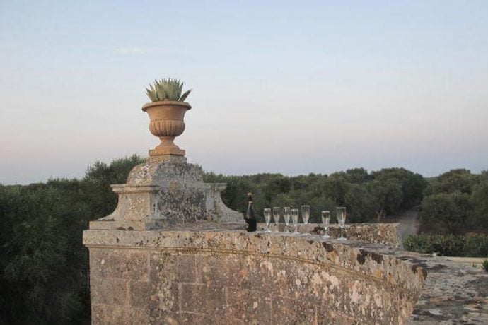 Stone wall, sunset and a line of Prosecco glasses