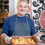 Flavours chef Antonio holding freshly prepared food.