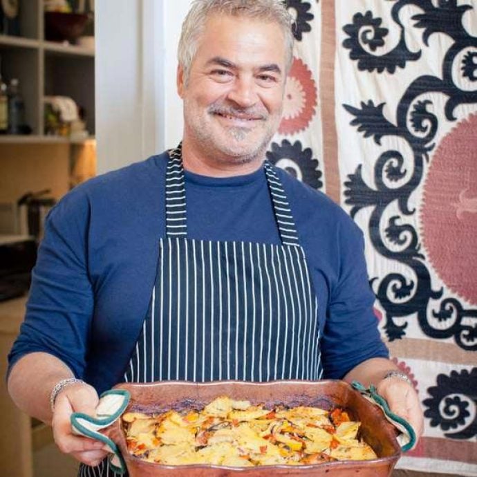 Flavours chef Antonio holding freshly prepared food.