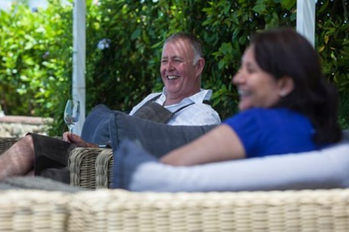 man and woman drinking prosecco and laughing