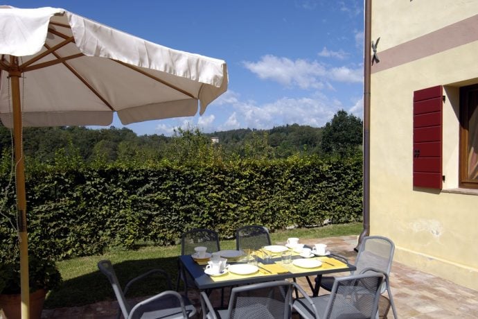 Outdoor patio table and chairs with umbrella.