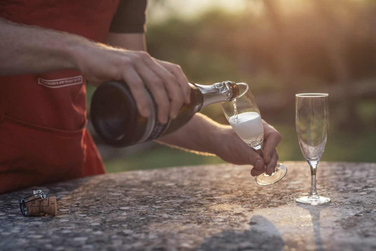 Flavours host pouring prosecco into glass
