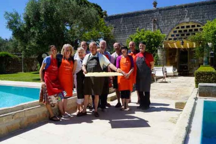 Group of cooking guests with freshly made food.
