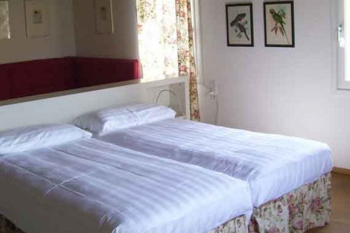 Comfortable double bed in spacious Italian holiday villa.