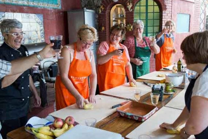 Group of people in Italian outdoor kitchen.