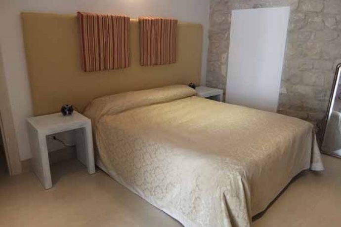 Modern interior of our painting holiday venue in Sicily with stone walls and furniture