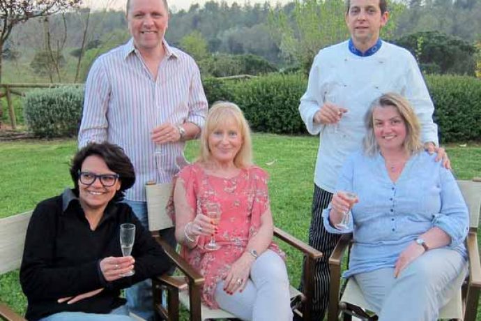 Italian chef with language guests outside drinking glass of wine