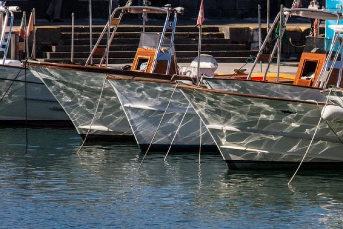 Glittery sea and floating boats in harbour in Amalfi coast