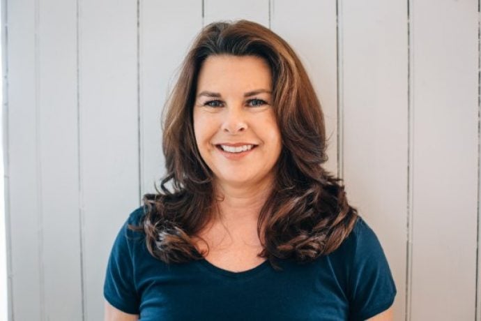 Diane Parrilla, the Pilates instructor in studio on mat exercising Pilates