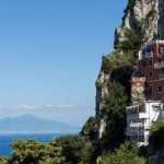 Cliffs and colourfull houses with Pompeii in the beackground