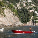 Italian young man on boat on the Amalfi Coast