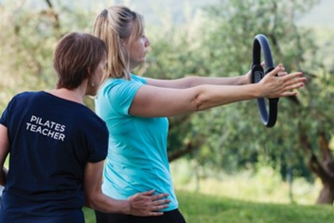 two women doing pilates outdoors