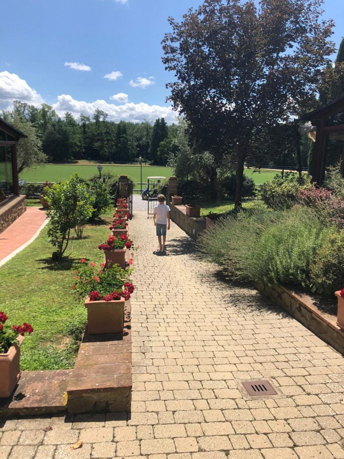 Sunny view of the path and gardens at La Martina